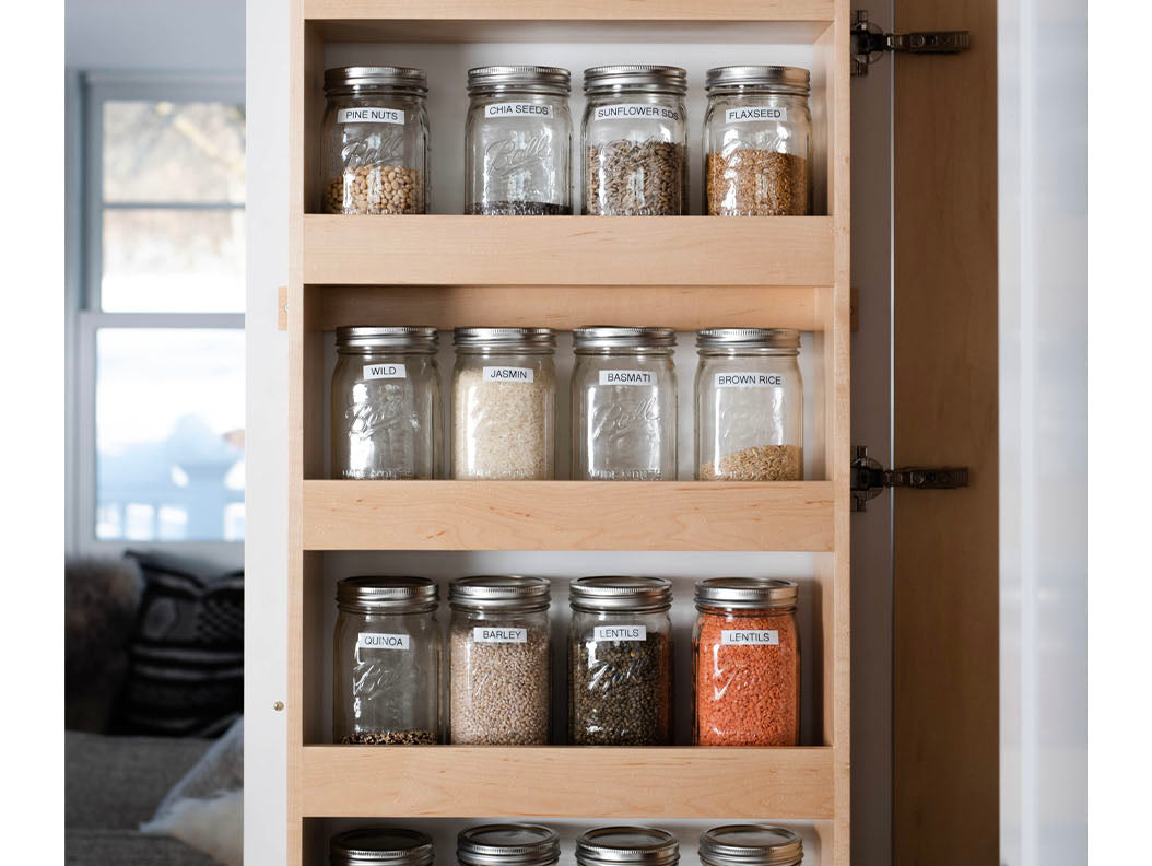 White kitchen with concrete counters and brass water stone faucets
