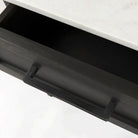 Square end table with black iron base, wood shelf and drawer and marble top on a white background