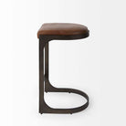 Black bar stool with iron base and U-shaped leather seat on a white background