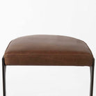 Black bar stool with iron base and U-shaped leather seat on a white background