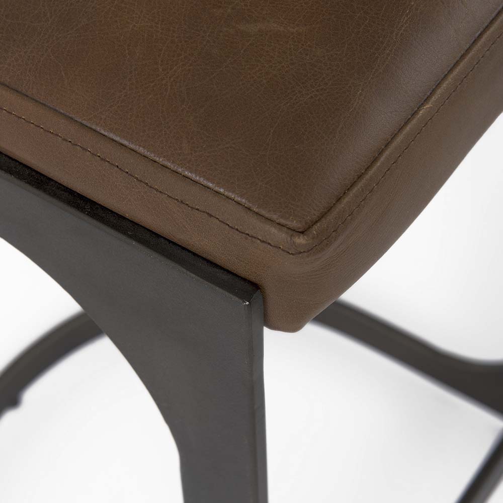 Black bar stool with iron base and U-shaped leather seat on a white background