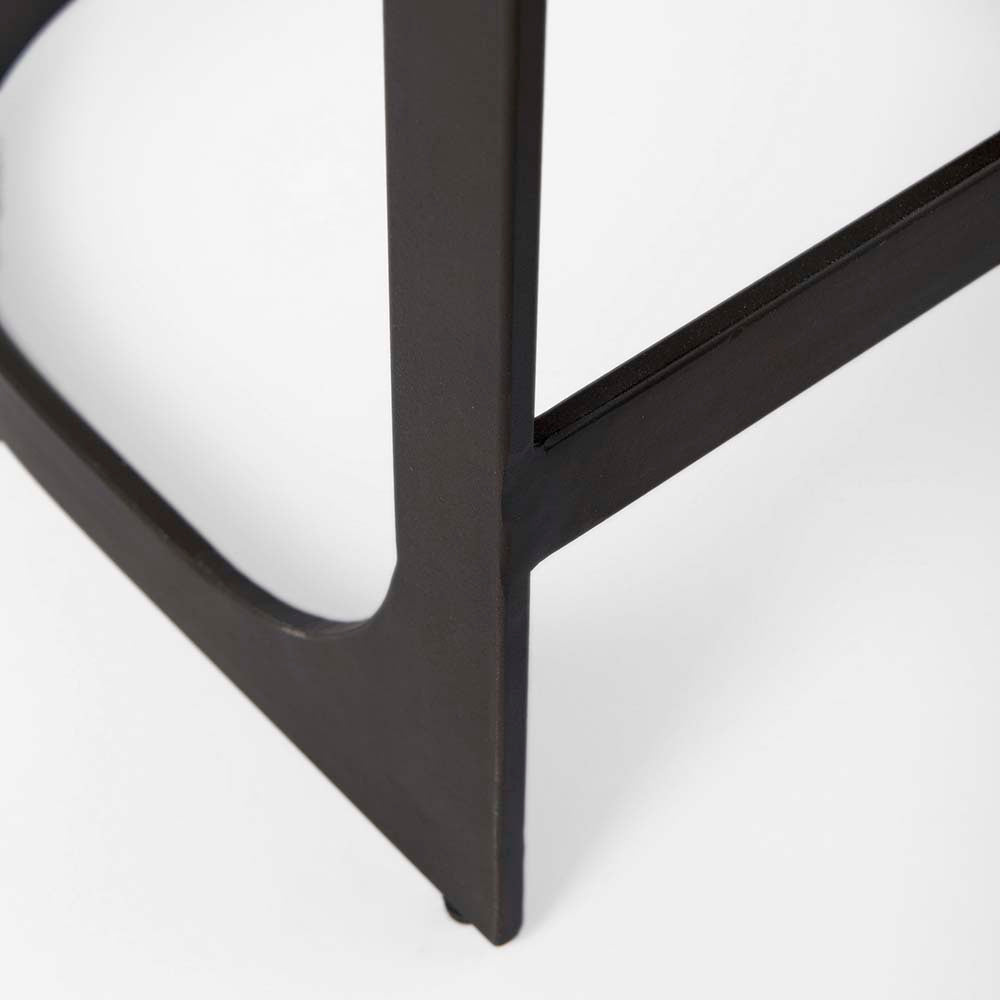 Black bar stool with iron base and U-shaped leather seat on a white background