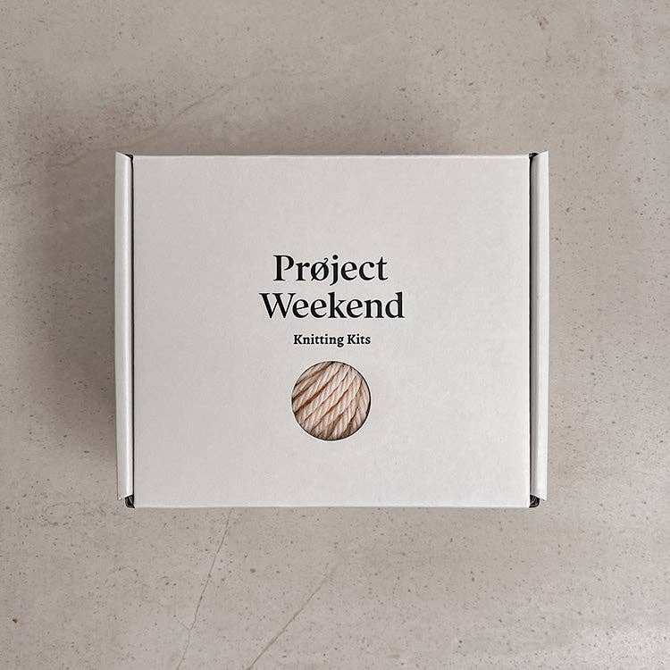 Knitting Craft Kit: Classic Pom Beanie in Medium Grey on a beige background at Addison West