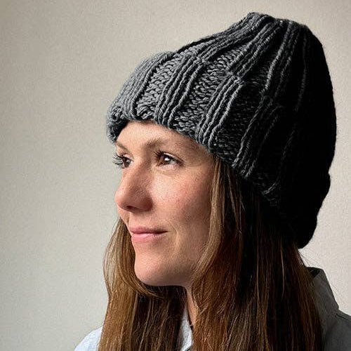 Knitting Craft Kit: Shoreline Beanie in Medium Grey on a beige background at Addison West