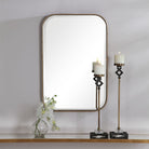 Marwell Vanity Accent Mirror on a white above a table at Addison West