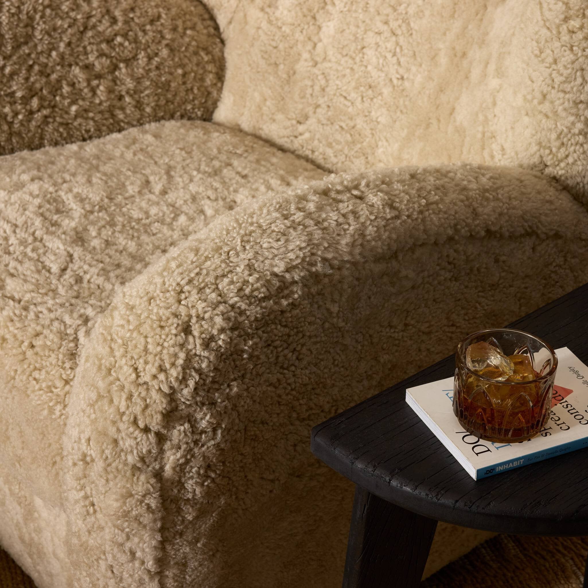 Four Hands Amelie Swivel Recliner in Beige Shearling in a living room at Addison West