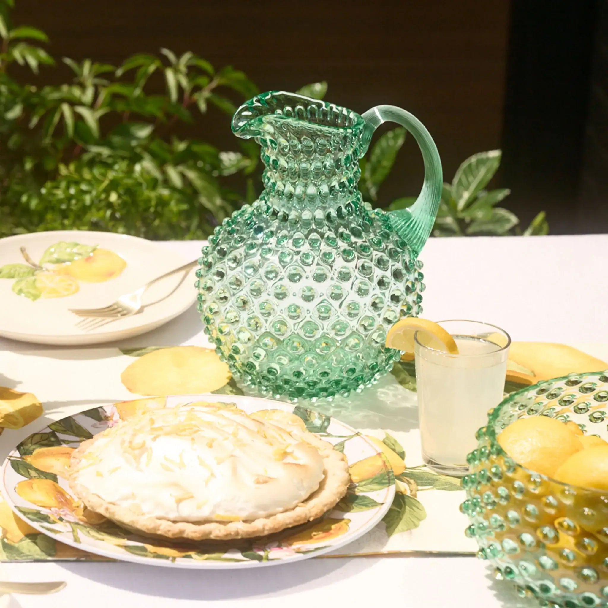 Hobnail Glass Pitcher in Capri Sea on a table at Addison West