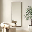 Patridge Full Length Mirror on a beige wall in a living room at Addison West