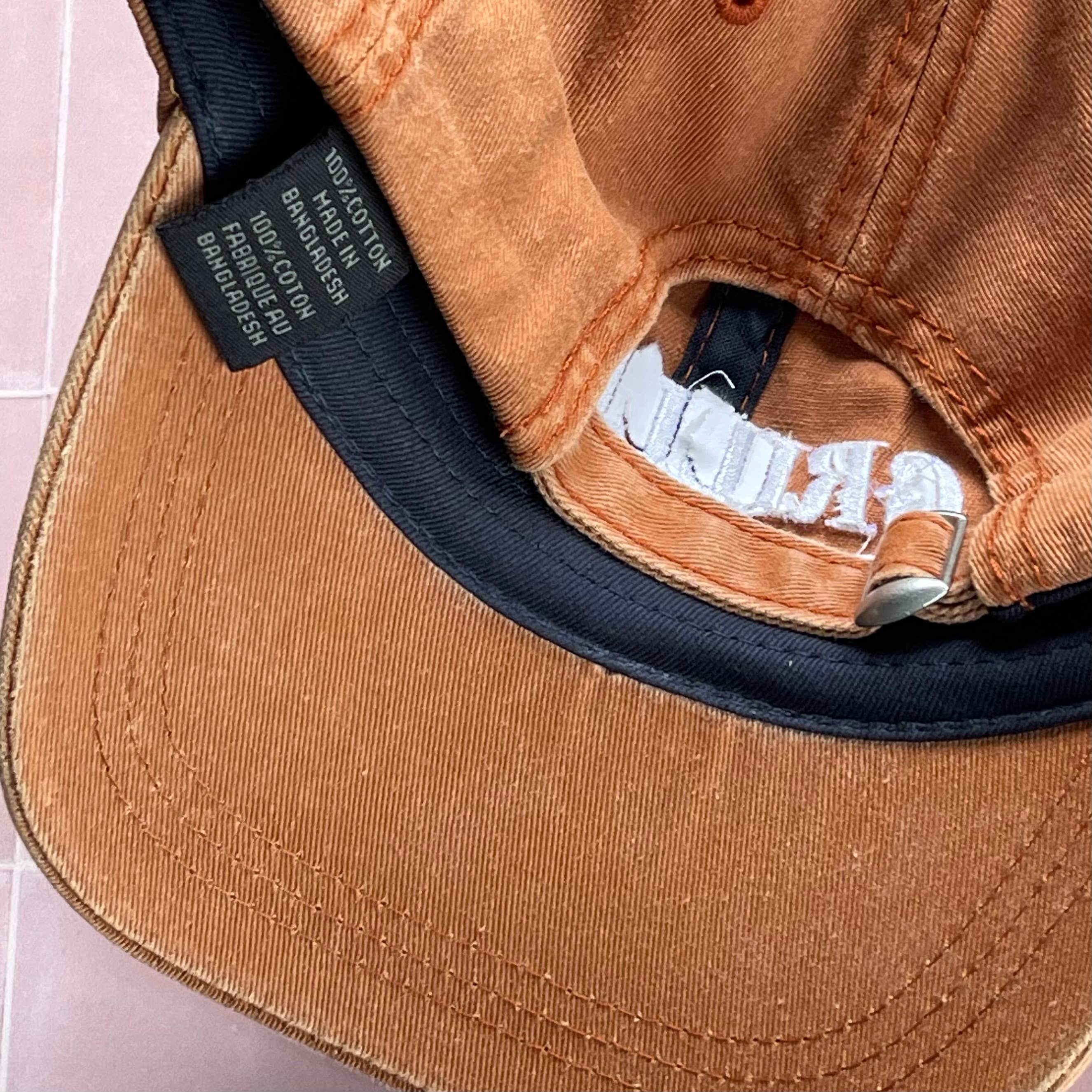 Inside of Grilled Cheese Baseball Hat on a pink background at Addison West