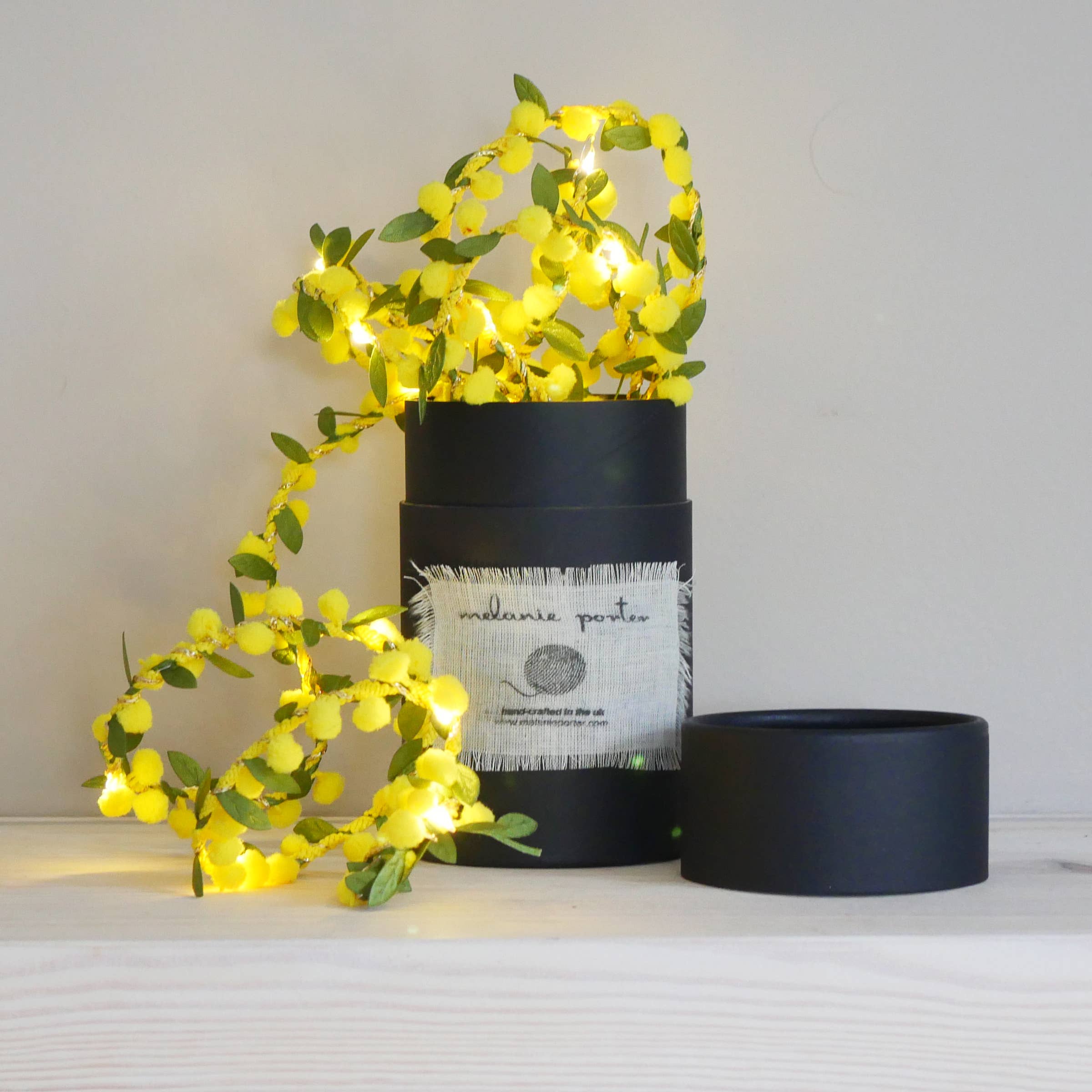 Spring Bud Fairy Light String in Yellow on a beige background at Addison West