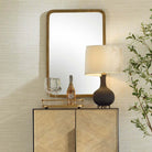 Vesden Accent Mirror on a beige wall above a table at Addison West