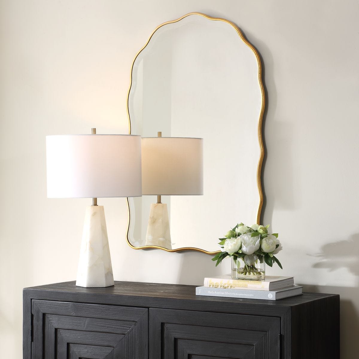 Maribelle Arch Accent Mirror on a white wall above a table at Addison West