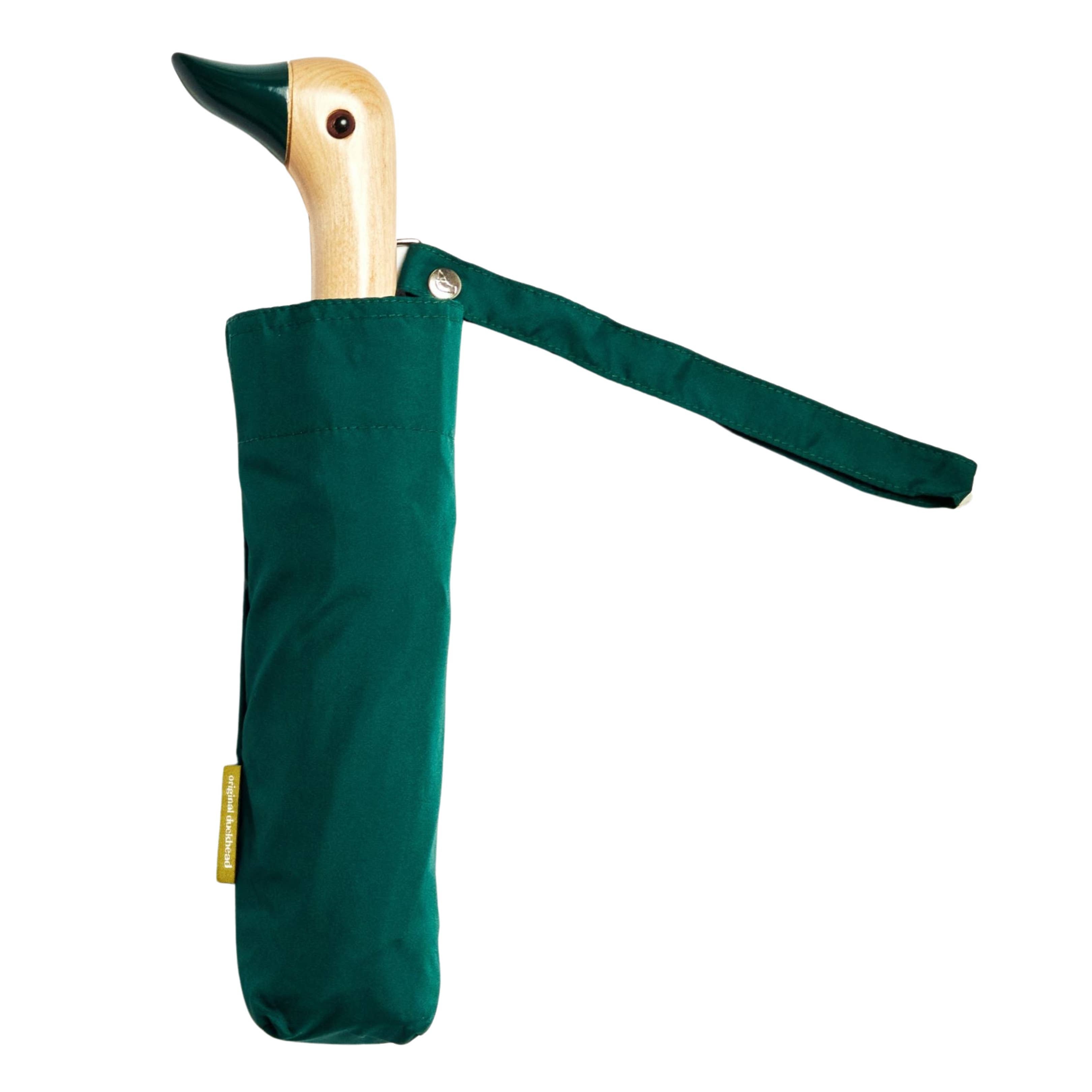 Green umbrella with wooden handle shaped like a duck on a white background