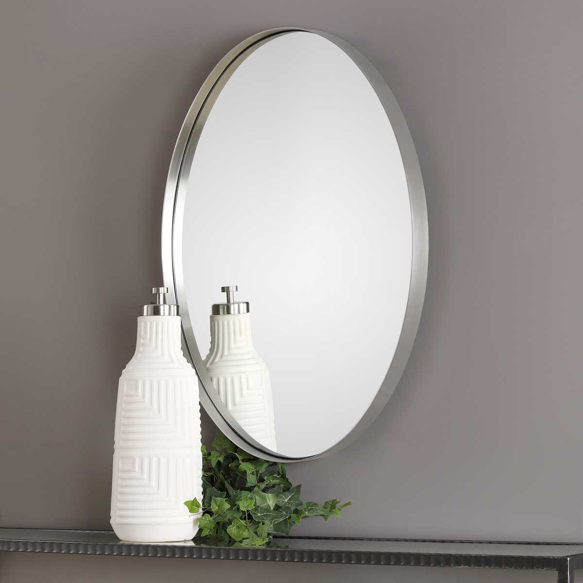 Purwell Oval Accent Mirror on a beige wall above a table at Addison Wet