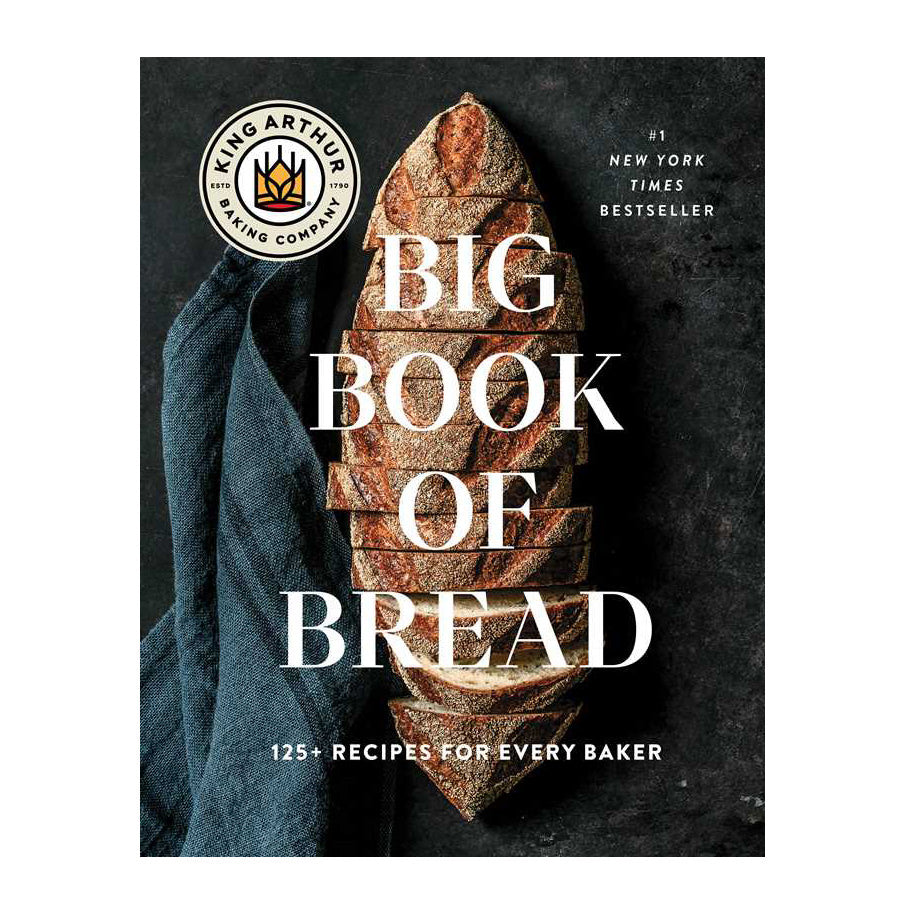 Book cover of 'Big Book of Bread' by King Arthur Baking Company with a loaf of bread and blue towel on a dark background.