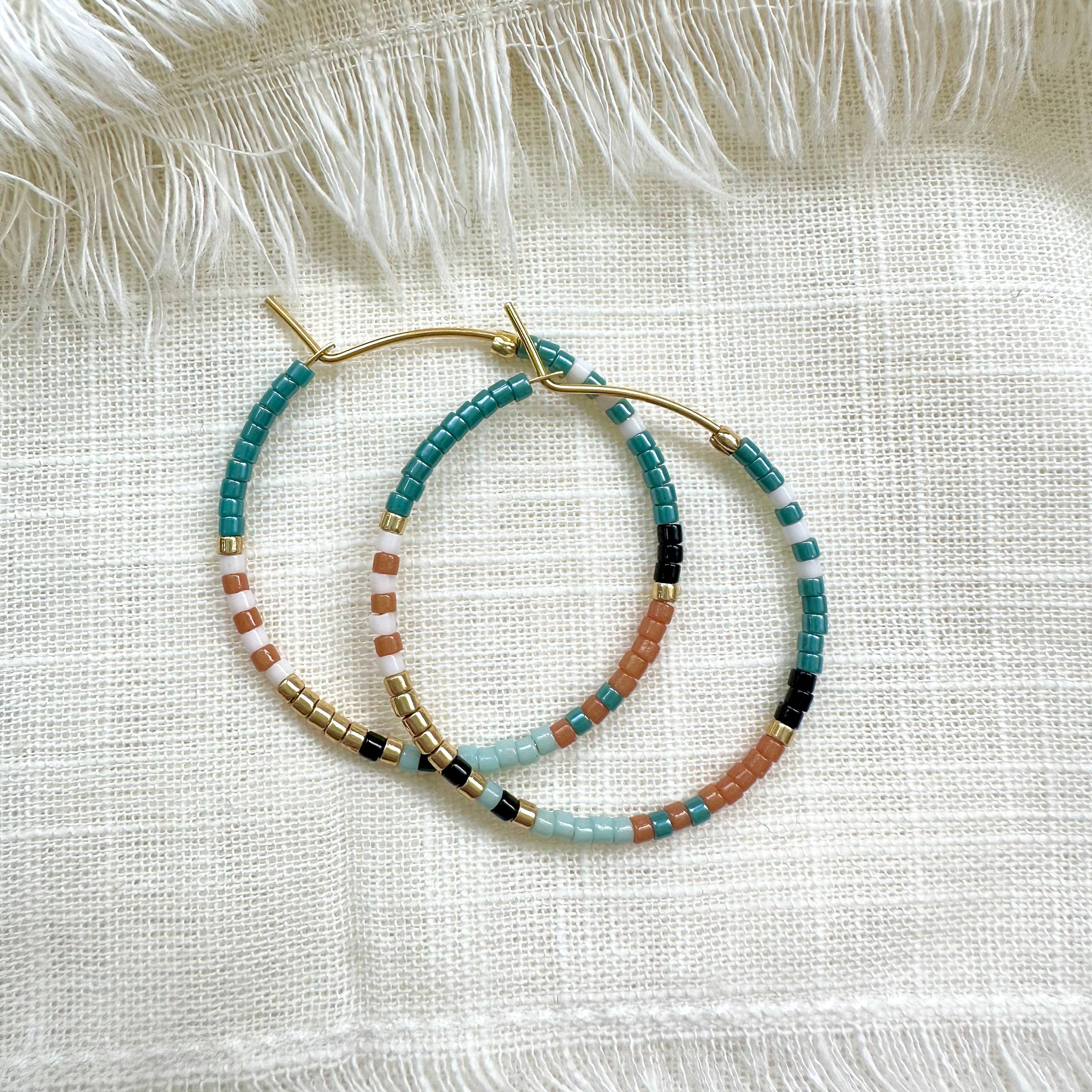 Ocean Breakup Bright Beaded Hoop Earrings in Blue on white background at the Addison West.