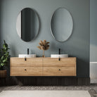 Purwell Oval Accent Mirror in a green bathroom at Addison West