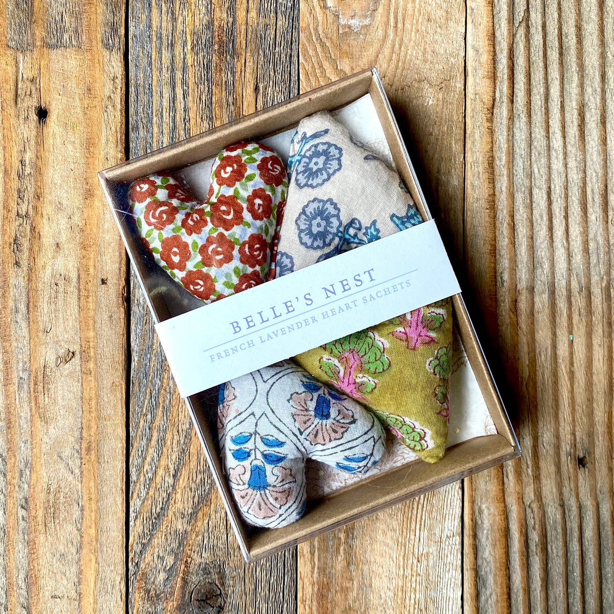 Mini Lavender Heart Sachets, Set of 4 on a wood table at Addison West