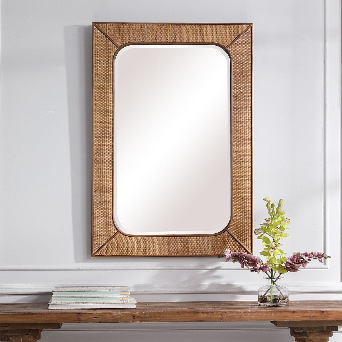 Tamera Accent Mirror on a white wall above a table at Addison West