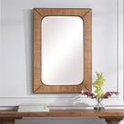 Tamera Accent Mirror on a white wall above a table at Addison West