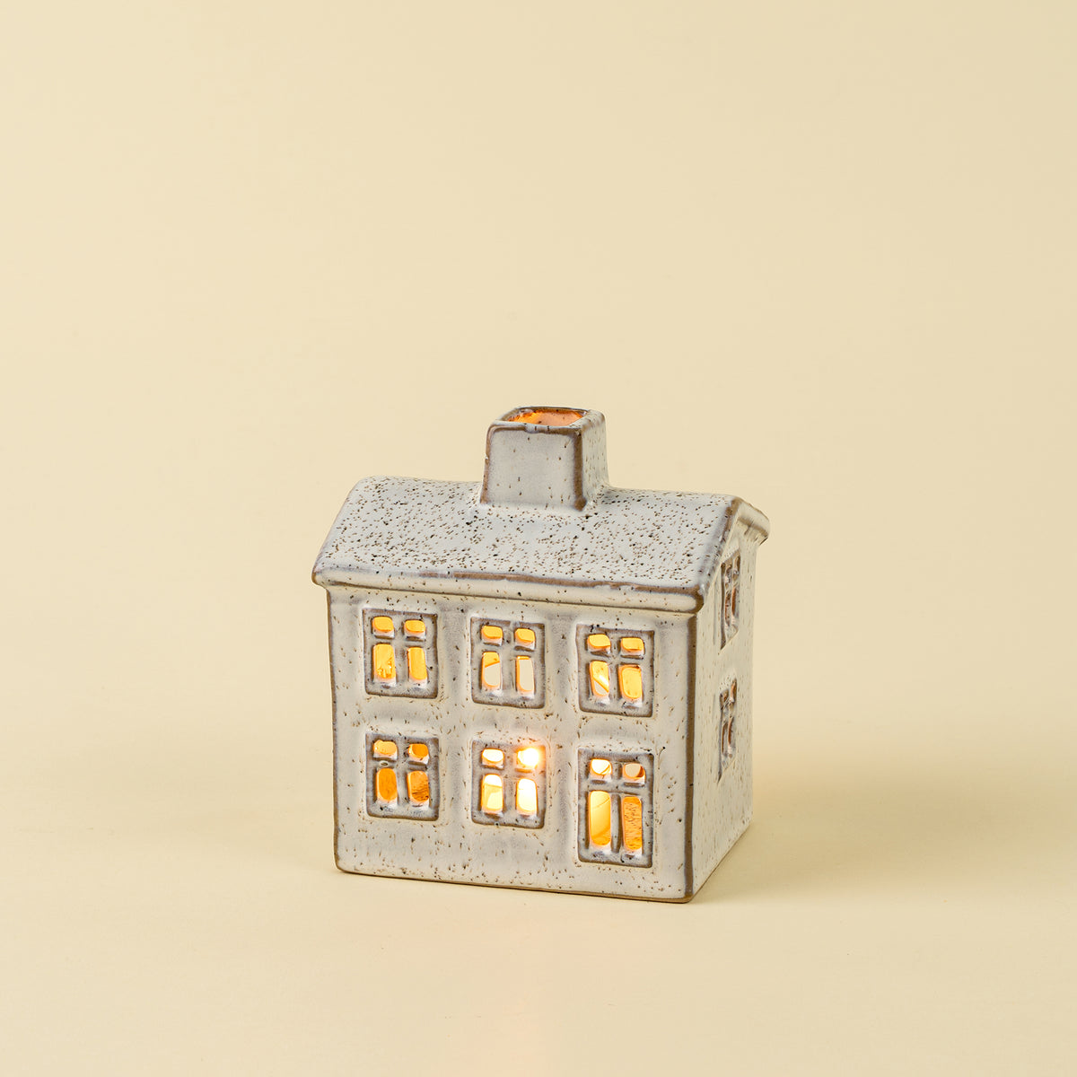 Small Winter Chalet Tealight House on a beige background at Addison West