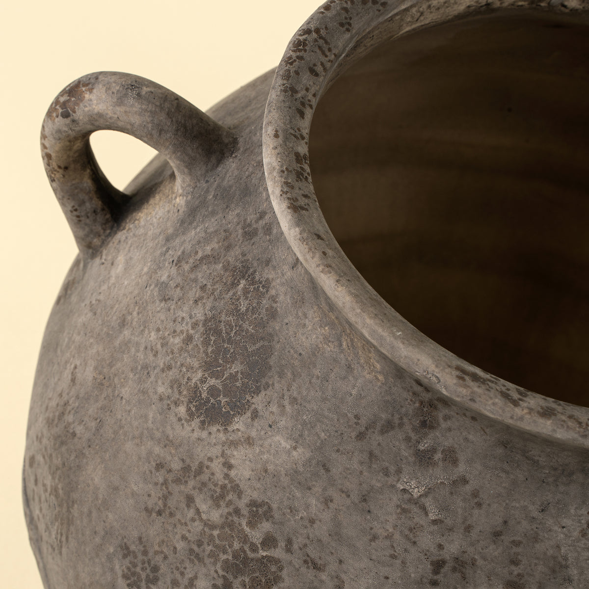 Small Artifact Stoneware Vase on a beige background at Addison West