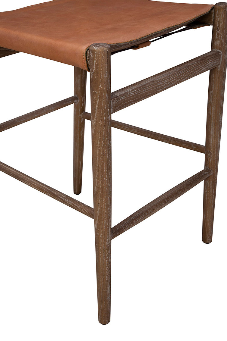 Close up of Leather Prescott Counter Stool on a white background at Addison West