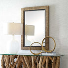 Islenne Accent Mirror on a white wall above a table at Addison West