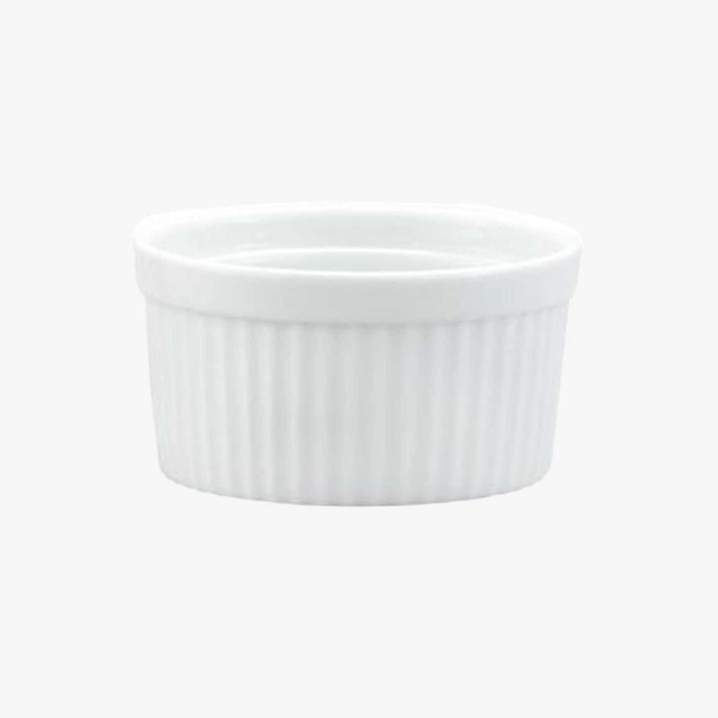 Small white ramekin with ridges on a white background