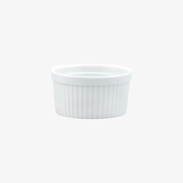 Small white ramekin with ridges on a white background