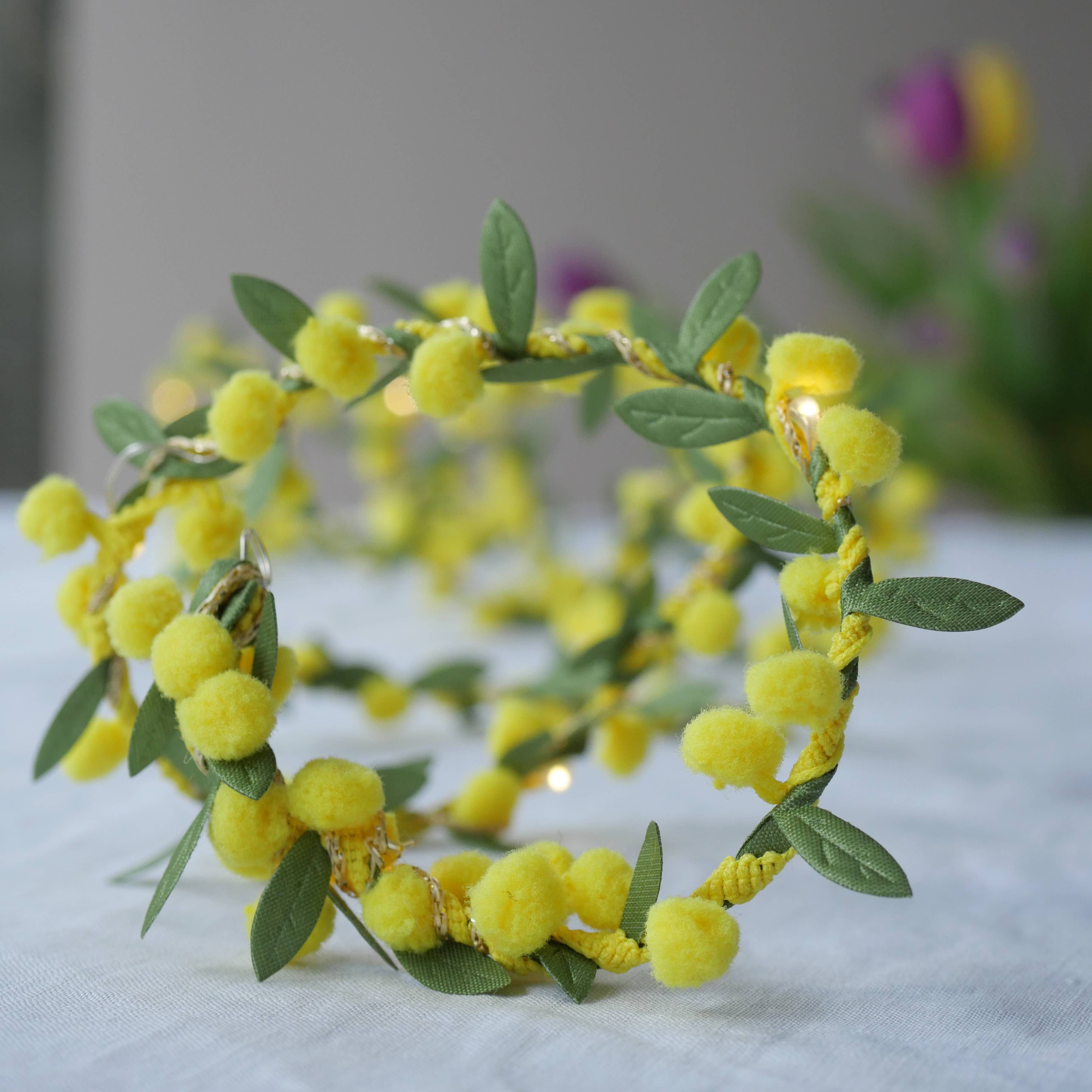 Spring Bud Fairy Light String in Yellow on a beige background at Addison West