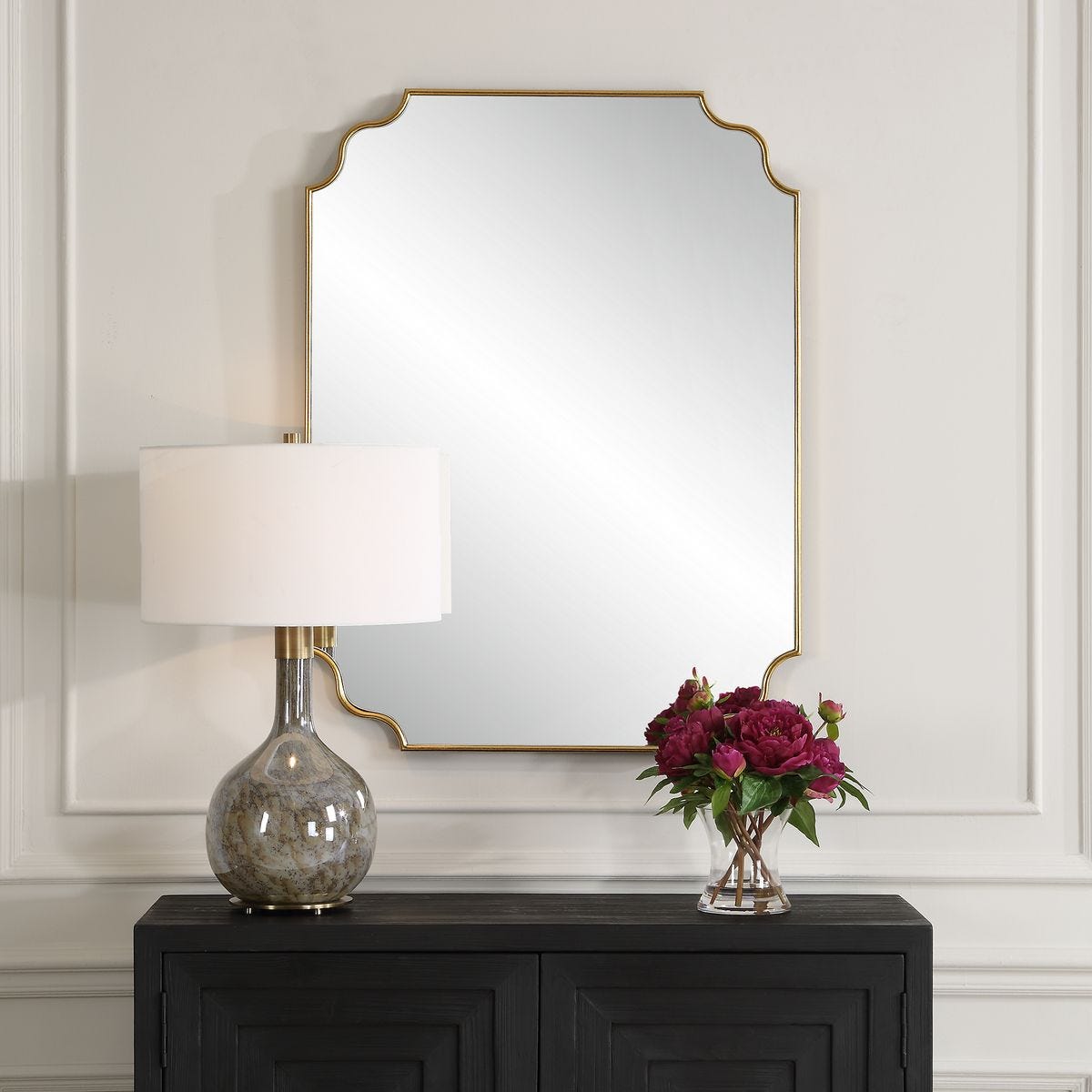 Lenora Accent Mirror on a beige wall above a table at Addison West