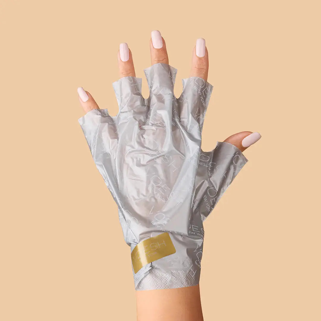 Collagen Gloves with Argan Oil & Floral Extracts on a orange background at Addison West