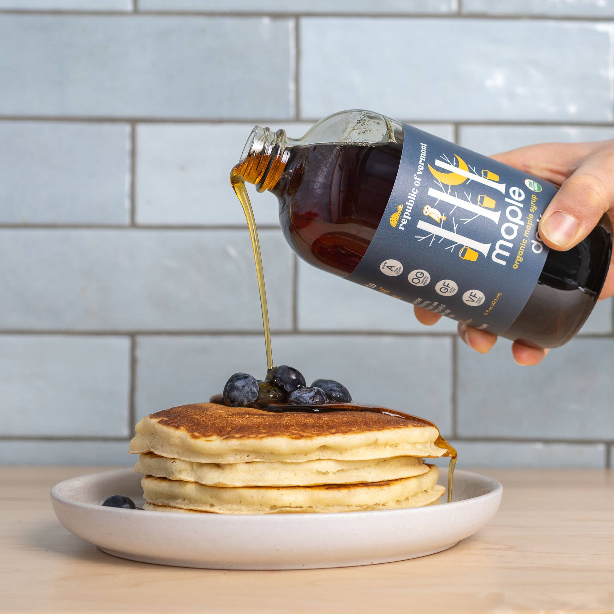 Organic Dark Maple Syrup poured over pancakes at Addison West