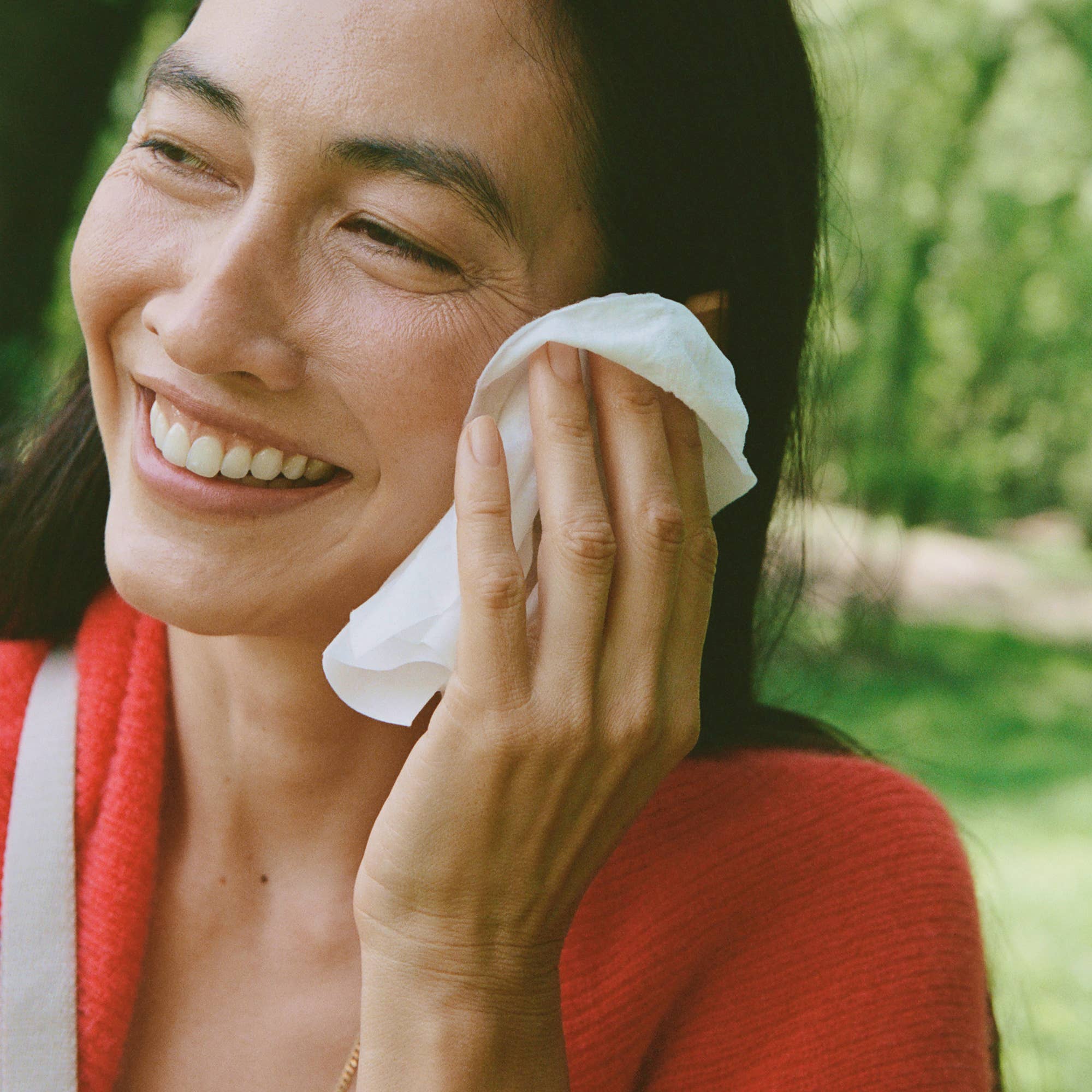 Ursa Major Essential Face Wipes held by a model at Addison West