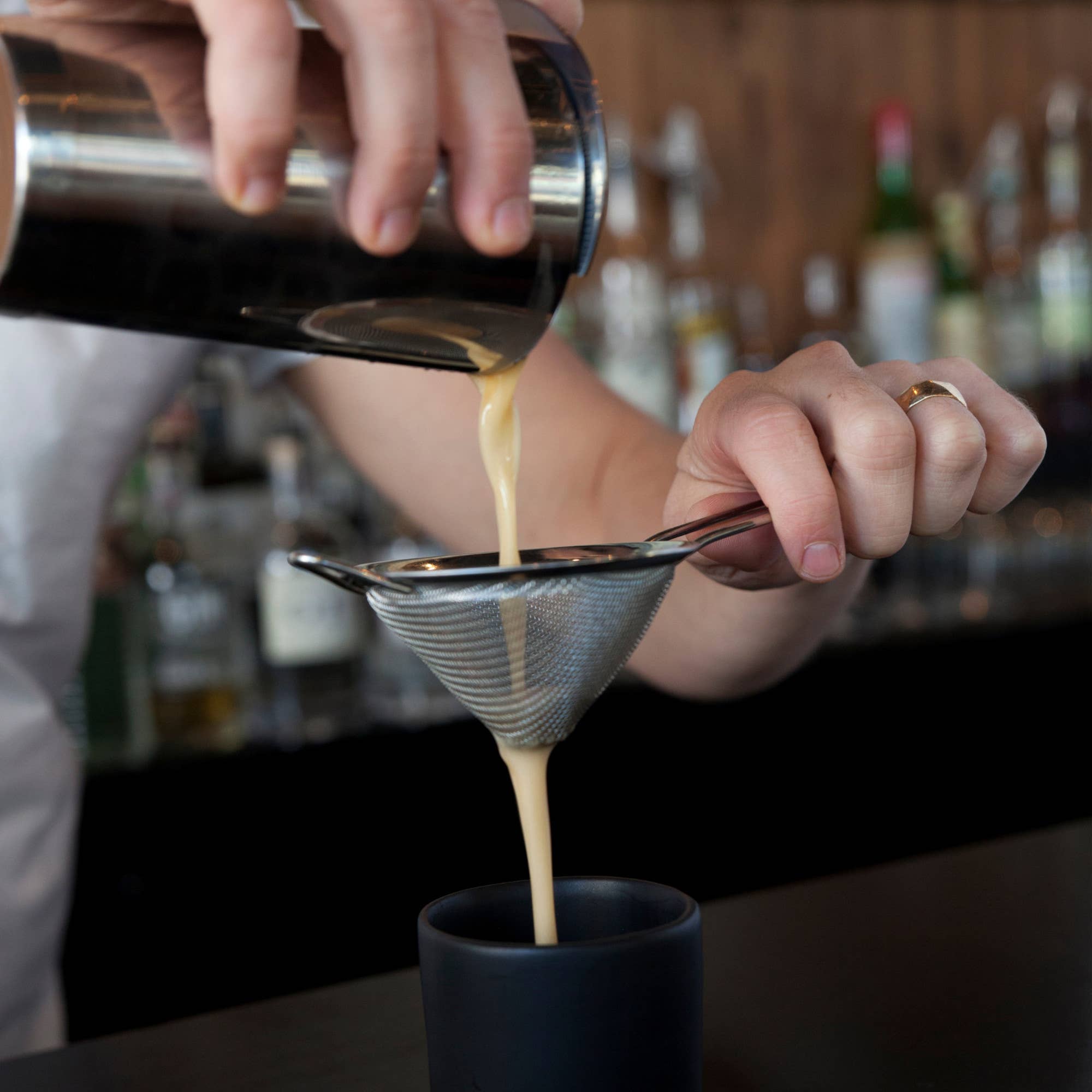 Harrison Stainless Steel Mesh Cocktail Strainer being used by a bartender at Addison West