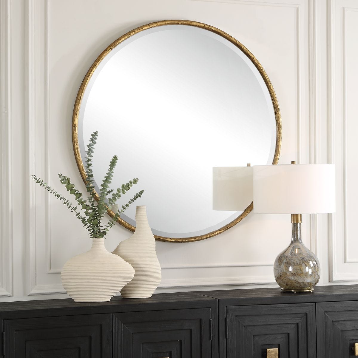 Sutcliffe Round Accent Mirror on a white wall above a table at Addison West