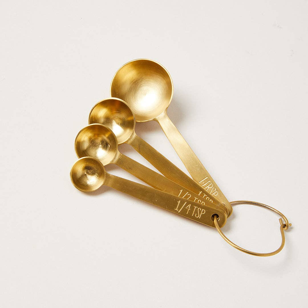 Stowe Measuring Spoons in Gold on a white background at Addison West