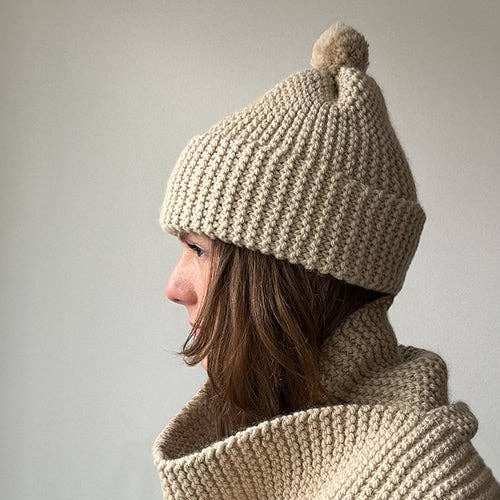 Knitting Craft Kit: Classic Pom Beanie in Sand on a beige background at Addison West
