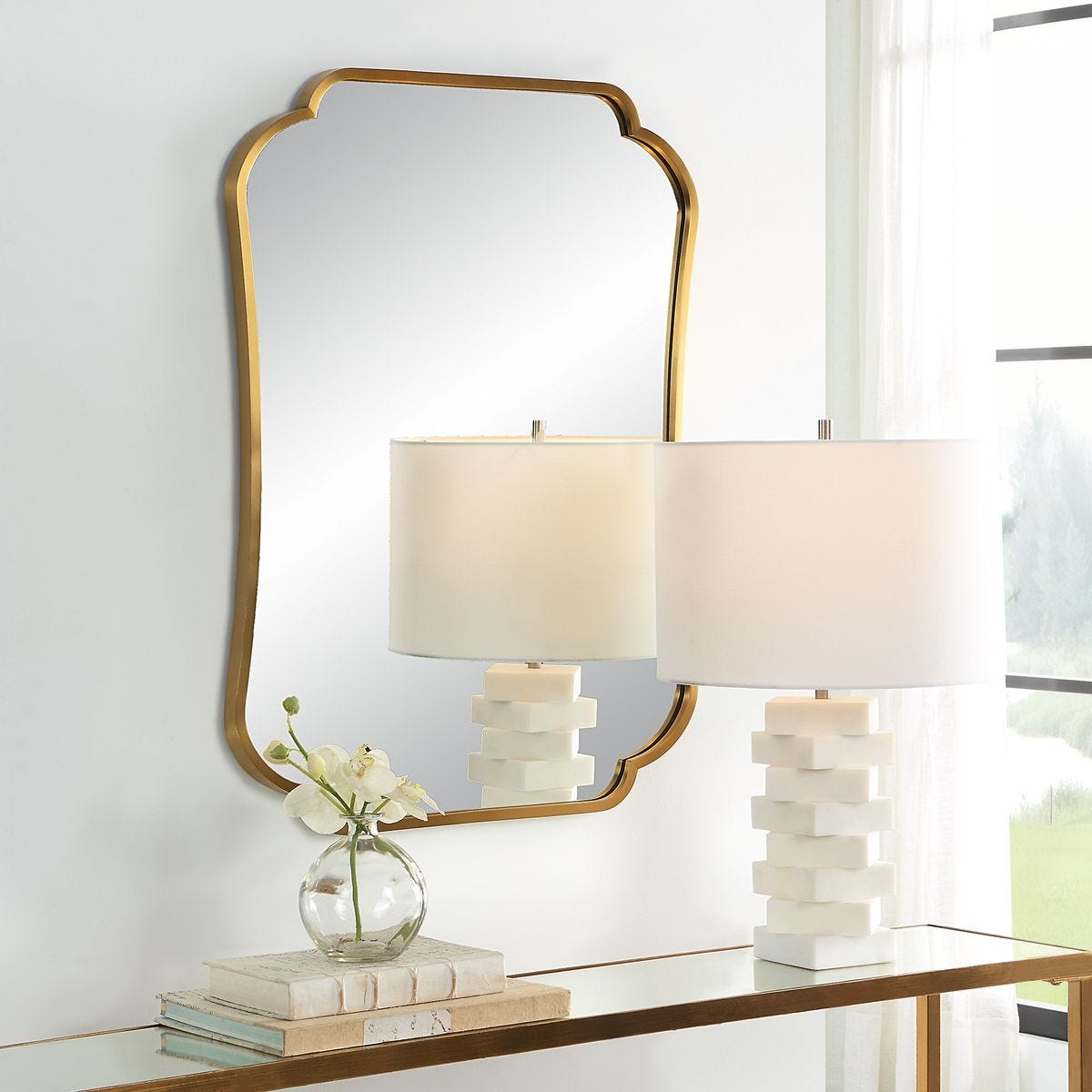 Atwell Accent Mirror on a white wall above a table at Addison West