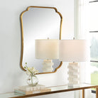 Atwell Accent Mirror on a white wall above a table at Addison West