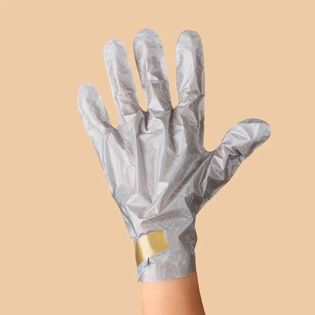 Collagen Gloves with Argan Oil & Floral Extracts on a orange background at Addison West