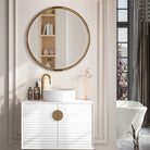 Finlow Round Accent Mirror on a beige wall in a bathroom at Addison West