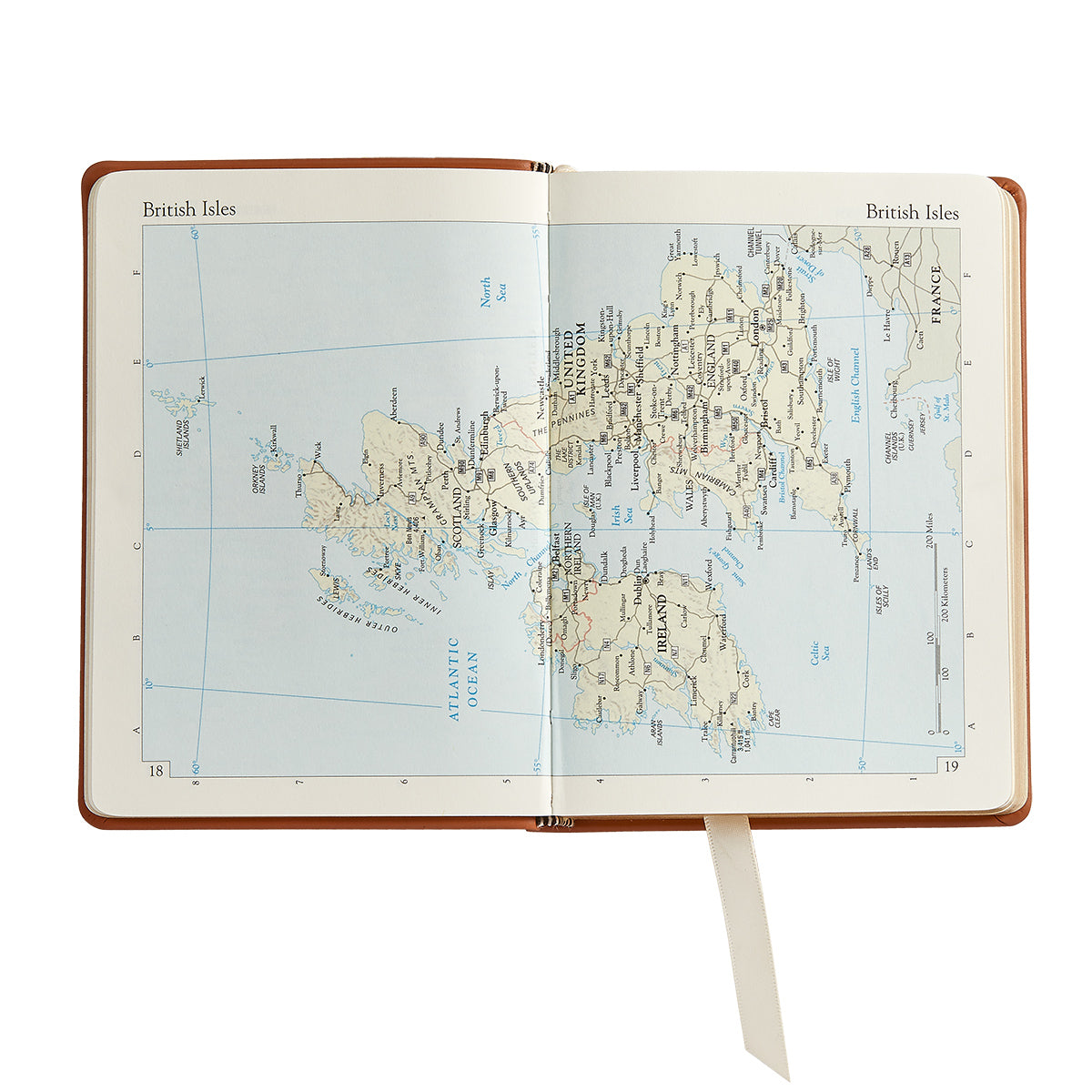 The Traveler's Atlas Cognac Leather on white background at Addison West.