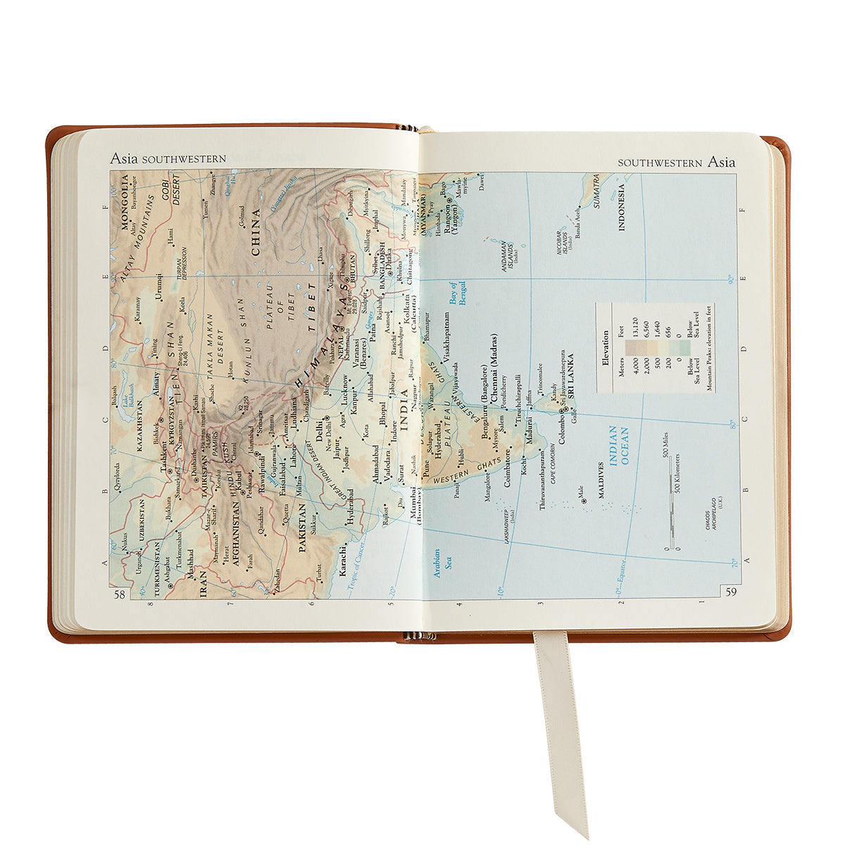 The Traveler's Atlas Cognac Leather on white background at Addison West.