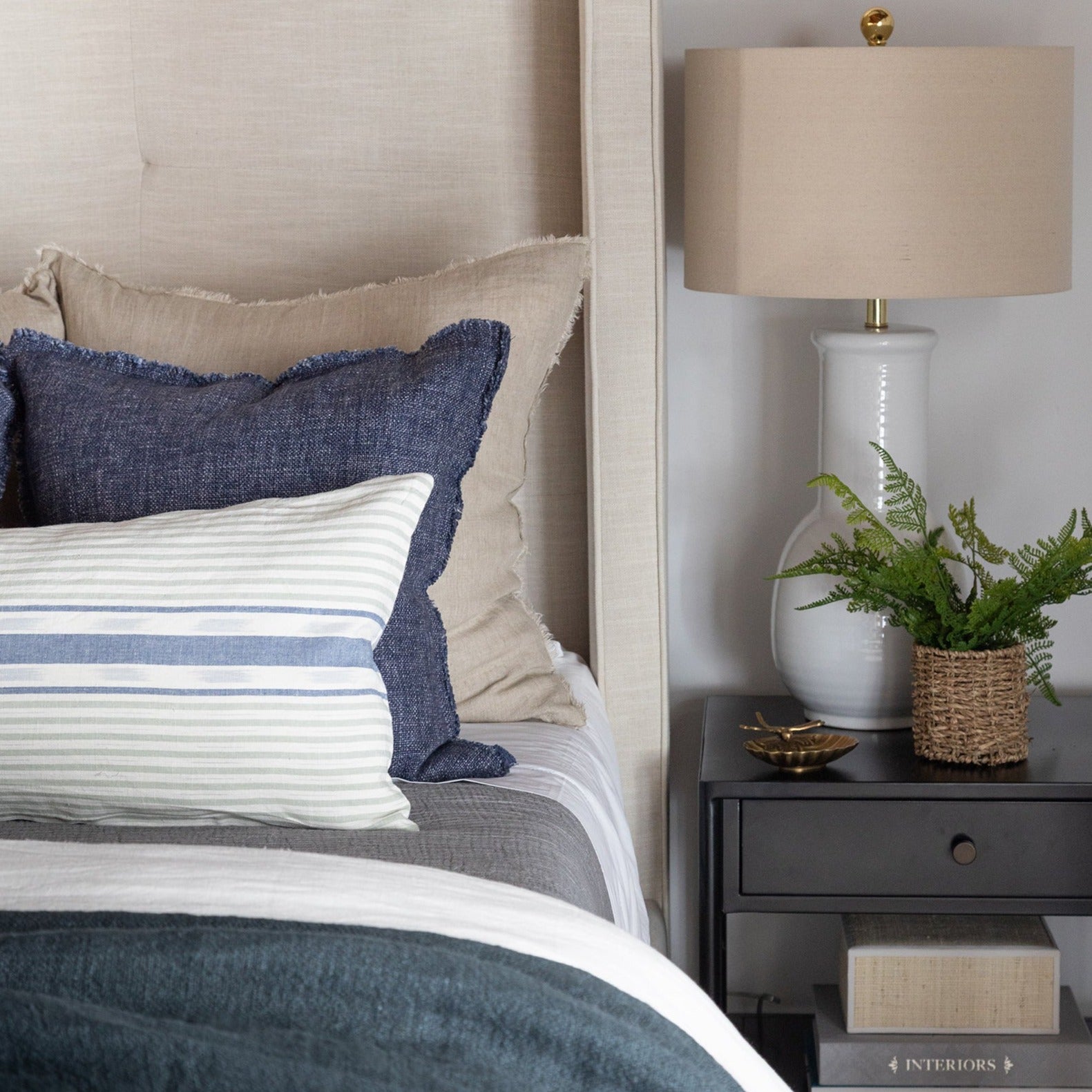 Seaview Linen 14" x 31" Long Lumbar Pillow and Selena 20" x 20" Linen Pillow in Navy Blue on a bed