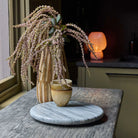 Abigail Ahern Faux Amaranthus in Blush on a wood table at Addison West