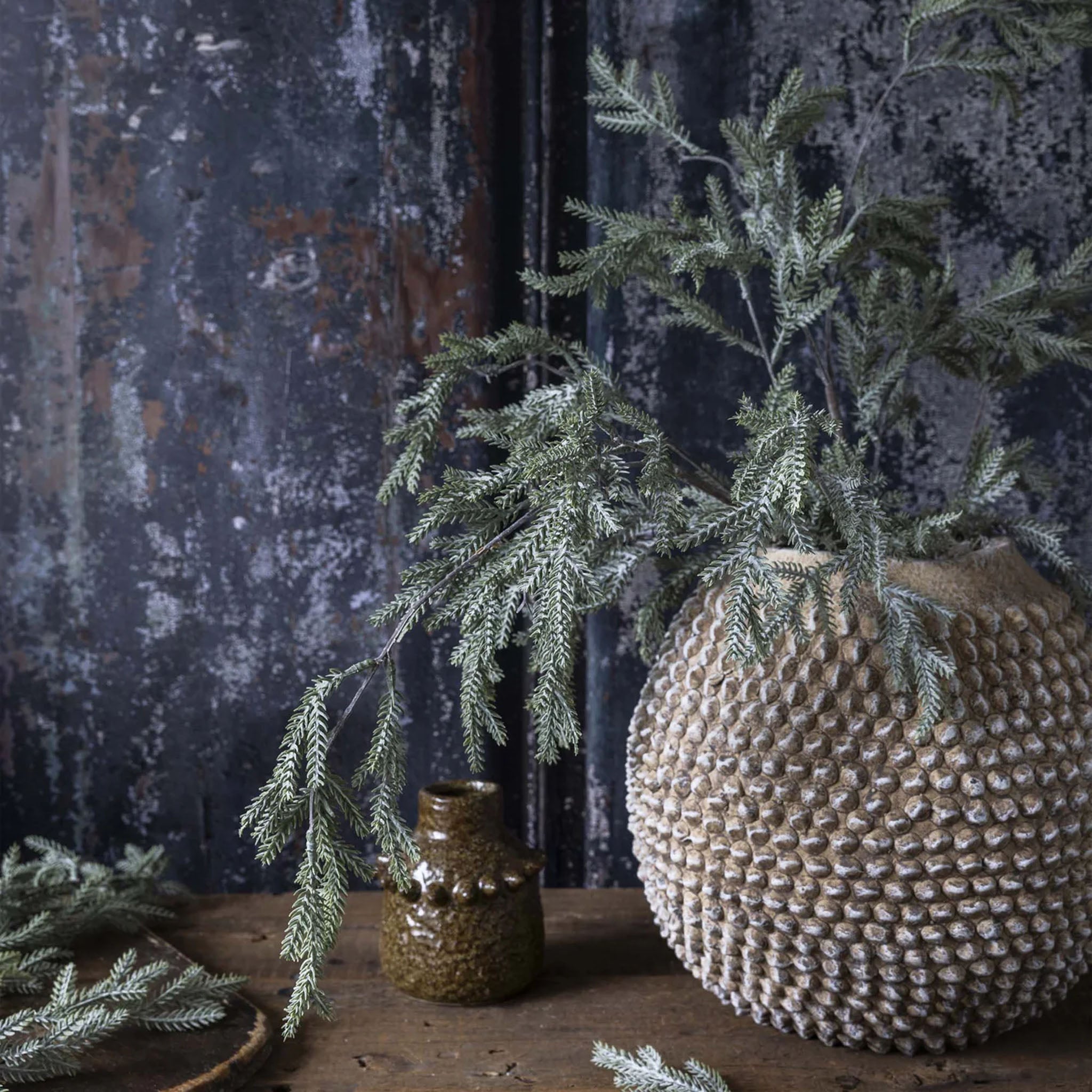 Abigail Ahern Faux Pine Branch in Frost on a grey background at Addison West