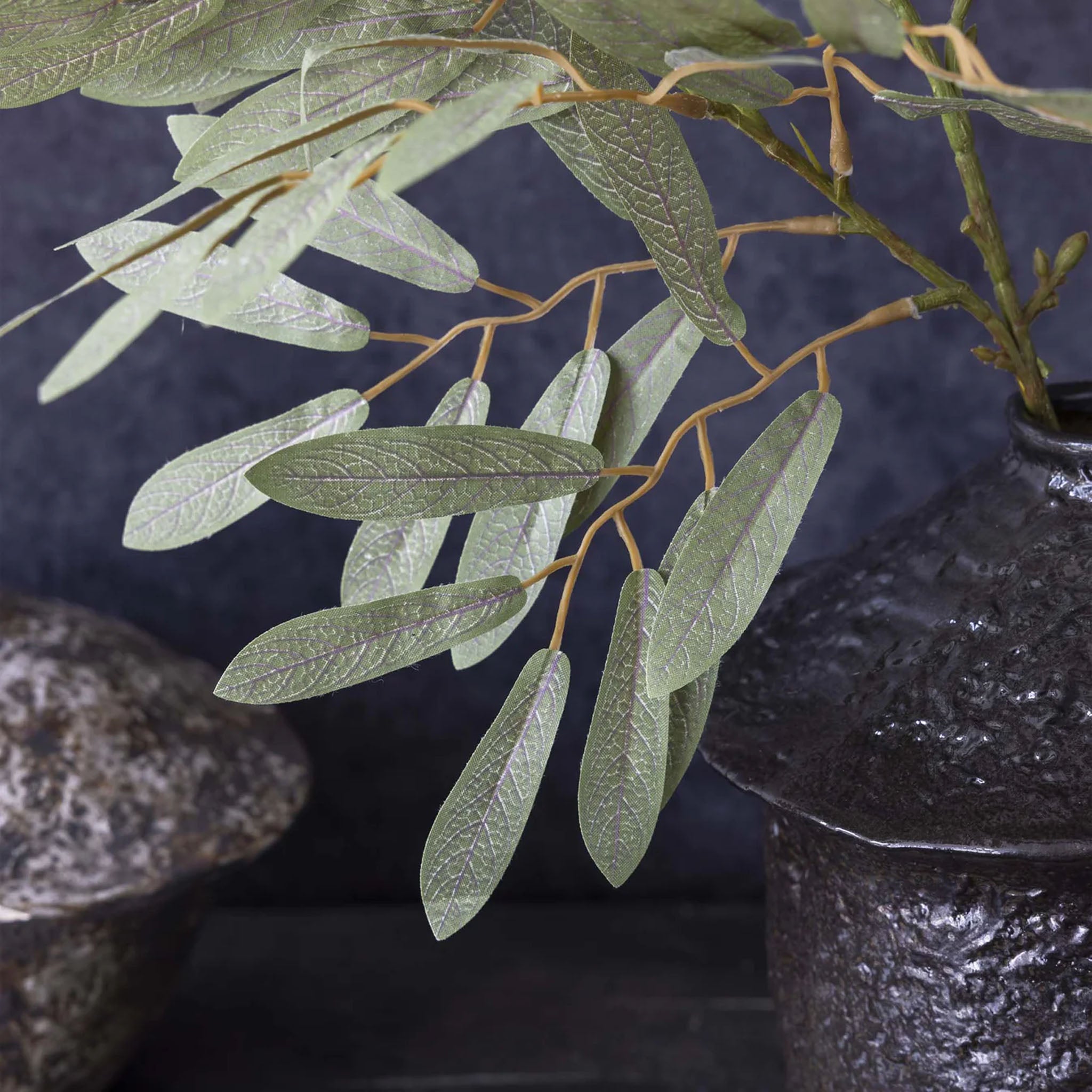 Abigail Ahern Faux Willow Stem in Soft Green on a grey background at Addison West