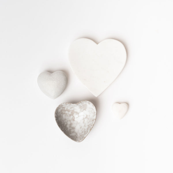 Four white heard dishes and decor items on a white background